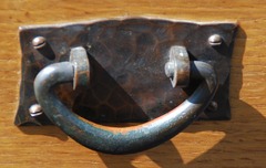 Detail original hand hammered copper pull with original patina.